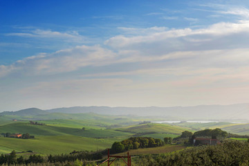 Fototapeta na wymiar Beautiful spring evening froggy landscape in Tuscany countryside, Italy