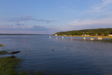 The Cap-Rouge River bay with boats moored in the St. Lawrence River during a summer golden hour morning