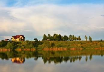 Fototapeta premium landscape with a house mirrored in the water