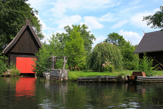 Waterscape of Spree Forest (Spreewald) with view to a traditional fish trap and view to a boathouse, Germany