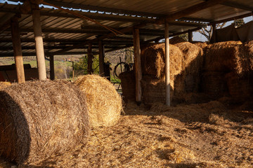 Some hay bales stacked in the barn