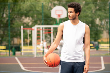 Young sportsman in activewear looking aside
