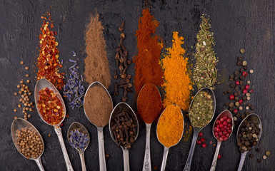 Spices and condiments for cooking on a black background