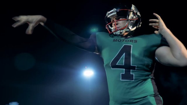 Footballer throws a ball, close up.