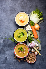 Variety of vegetable soups in bowl with ingredients, broccoli, champignon, fennel, cauliflower soups, clean eating, dieting and healthy food concept