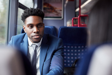 Business Passengers Sitting In Train Commuting To Work Having Discussion