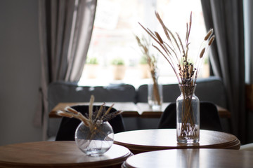 dried flowers in a vase on the background of the interior of the cafe