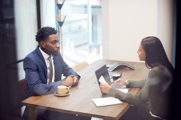 Businesswoman Interviewing Male Job Candidate In Meeting Room - obrazy, fototapety, plakaty