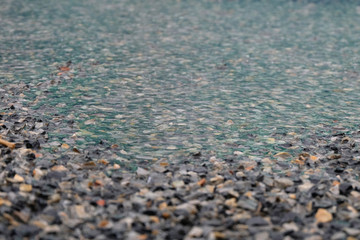 Rain drops rippling in a puddle