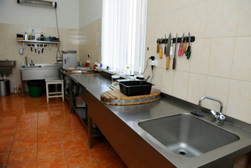 At the kitchen: sink, butcher's knives, other kitchen utensils