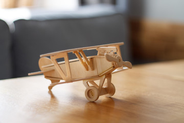 wooden airplane helicopter toy assembled in the interior with blurred background