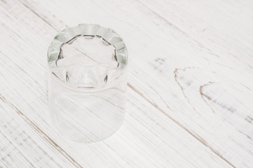 Empty glass on a white wooden background.