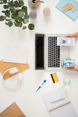View of human hands holding jar with pills while searching for medicine to buy