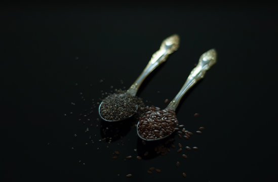 excellent image for the kitchen on a black background inseparable flaxseeds and chia seeds for healthy people