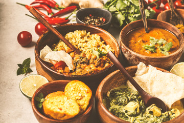 Food traditional Indian cuisine. Dal, palak paneer, curry, rice, chapati, chutney in wooden bowls on white background.