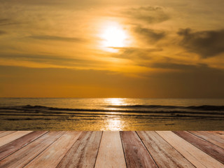 Fototapeta na wymiar Wood table top over golden hour sunrise summer sea background.