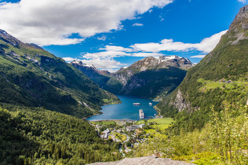 Norway cruise, mountains and village in Geiranger fjord.
