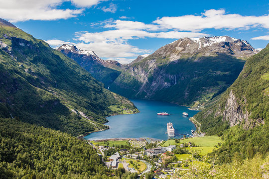 Norway cruise, mountains and village in Geiranger fjord.
