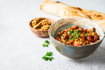 Georgian traditional beans lobio in bowl on a white-gray background.