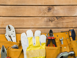 Pouch with implements of carpenter on table