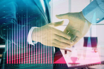 Multi exposure of financial graph on office background with two businessmen handshake. Concept of success in business