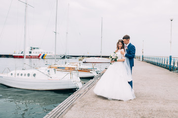 Wedding couple on the yacht, lovers posing on the yacht
