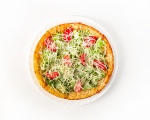 Caesar pizza with chicken on a plate top view