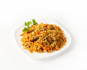 Pilaf with beef on a plate on a white background side view