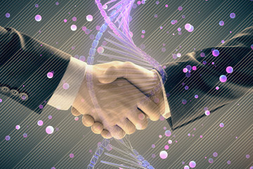 Multi exposure of DNA hologram on abstract background with two men handshake. Concept of...
