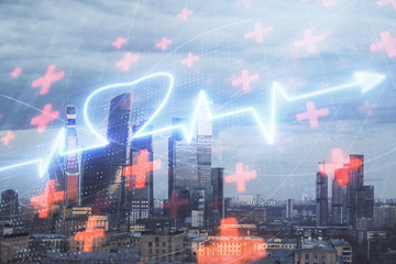 Fototapeta premium Multi exposure of human heart hologram on Moscow cityscape background. Concept of medical education