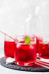 Fototapeta na wymiar Red alcoholic coctail with ice and mint
