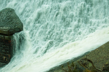 Water flowing over the top of the dam at Elan valley..