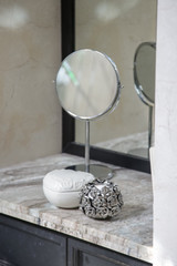 Vanity table, mirror and jewelry boxes on the elegant marble desk