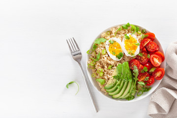 quinoa with boiled egg, avocado, tomato, arugula. healthy breakfast