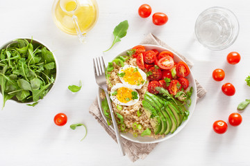 quinoa with boiled egg, avocado, tomato, arugula. healthy breakfast