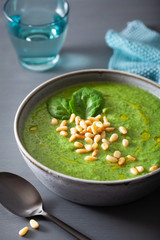green creamy cauliflower spinach soup on gray background
