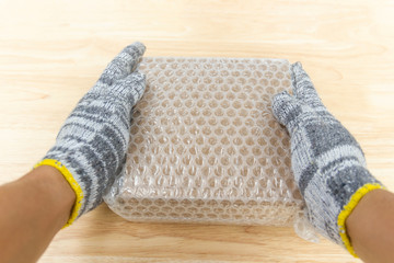 hand of man hold bubble wrap, for protection parcel product cracked or insurance During transit