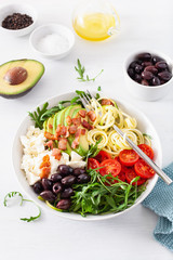 ketogenic lunch bowl: spiralized courgette with avocado, tomato, feta cheese, olives, bacon