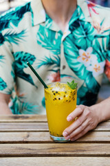 guy holds passion fruit lemonade