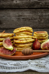 homemade corn pancakes with sour cream, nuts and figs