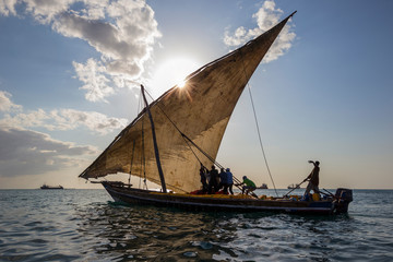 Fototapeta na wymiar traditional dhow sailing boat setting sail for the open ocean and destination harbors