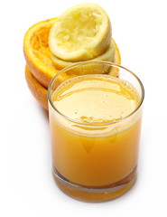 Organic mix juice in glass with peel lemon and orange isolated on white, top view