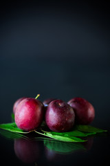 organic red ripe cherry plum isolated on black