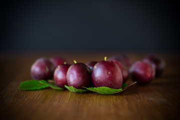 organic red ripe cherry plum isolated on black