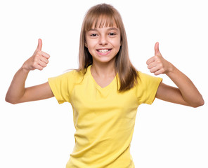 Close-up emotional portrait of caucasian little girl. Funny kid making thumbs up gesture, isolated on white background. Beautiful child laughing looking very happy.