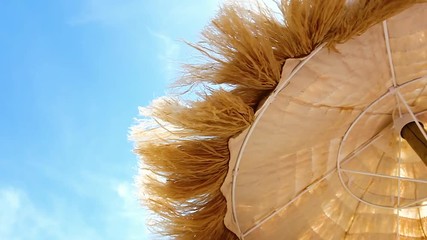 View from below of beautiful thatched umbrellas on the beach, great recreation and relaxation.