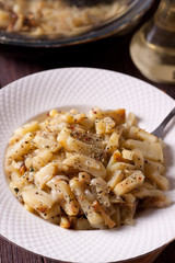 Fried potatoes with onions and seasonings on a white plate