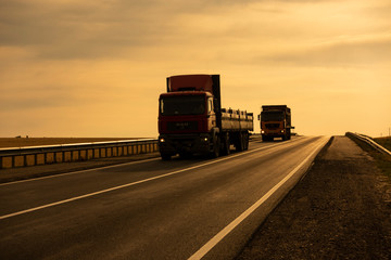 Truck driving on the asphalt road rural landscape