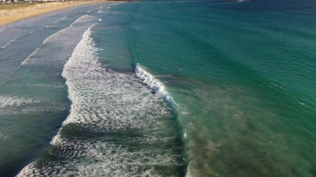 ocean waves sandy beach with people bathing in the water view from drone Lanzada beach Galicia Spain 4k video