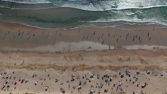 ocean waves sandy beach with people bathing in the water view from drone Lanzada beach Galicia Spain 4k video